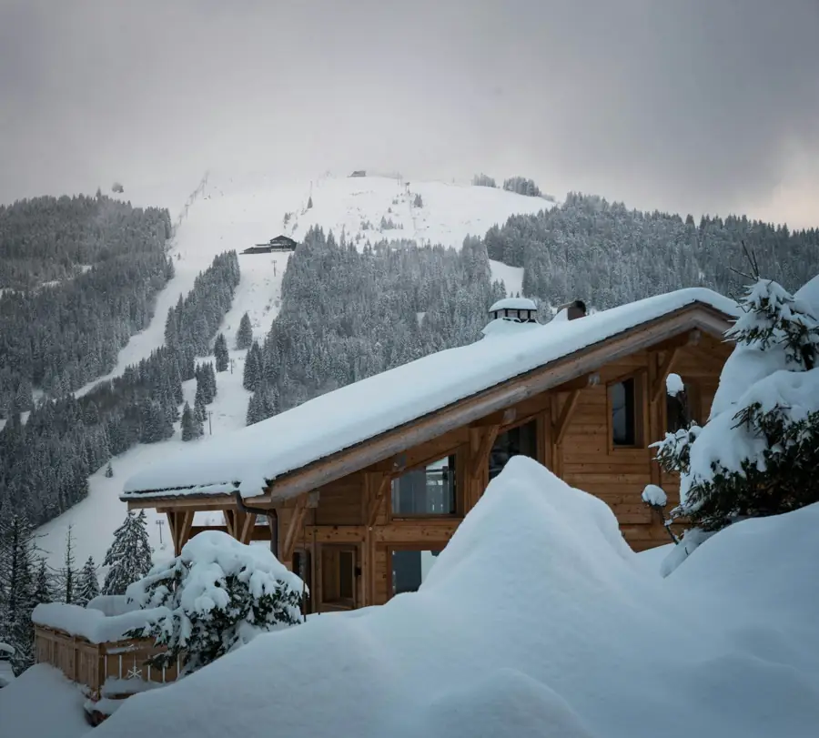 Wooden chalet under deep snow