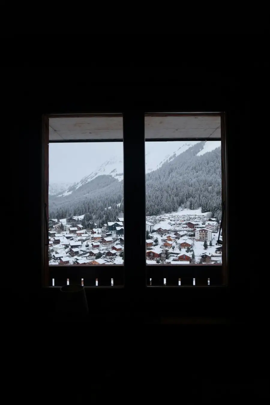 Snowy village seen through a window