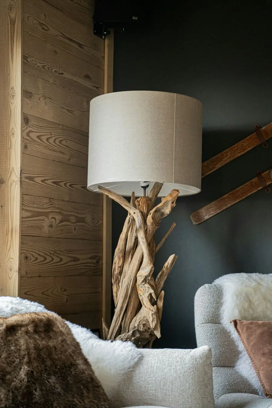 Warm chalet living room with a driftwood lamp